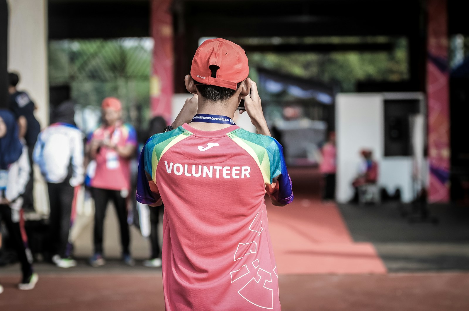 voluntary person standing wearing red shirt
