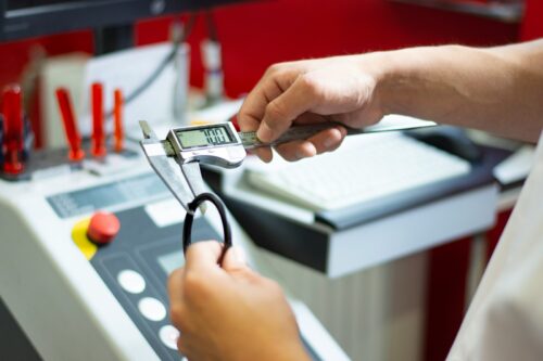 Qualitätsmanagement: a person using a calculator on a machine